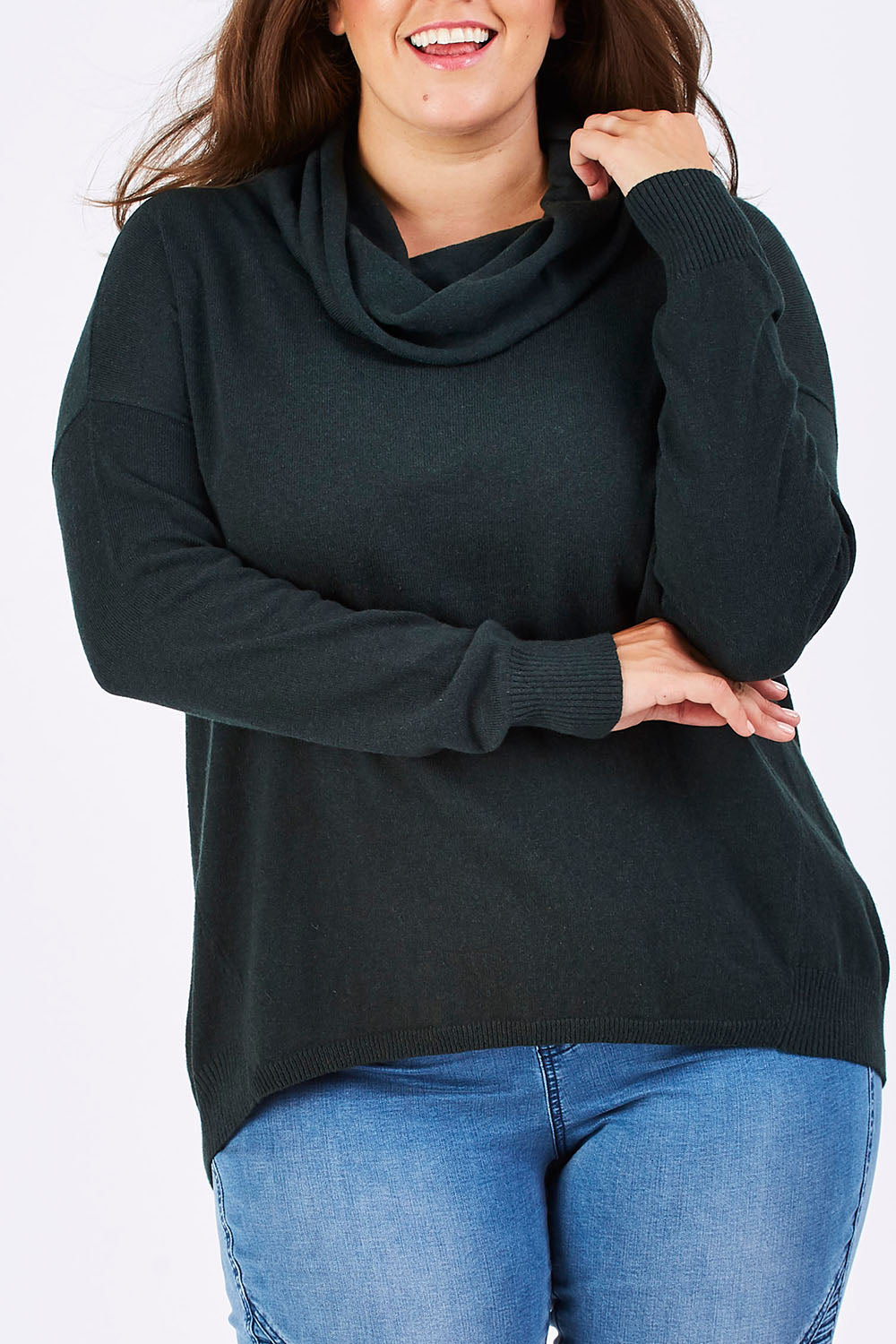 Model Mae wearing size XL of the Natural Rolled Neck Sweater in colour Alpine (Green), from the front, cropped image