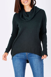 Model Perrie wearing size S of the Natural Rolled Neck Sweater in colour Alpine (Green), from the front, cropped image