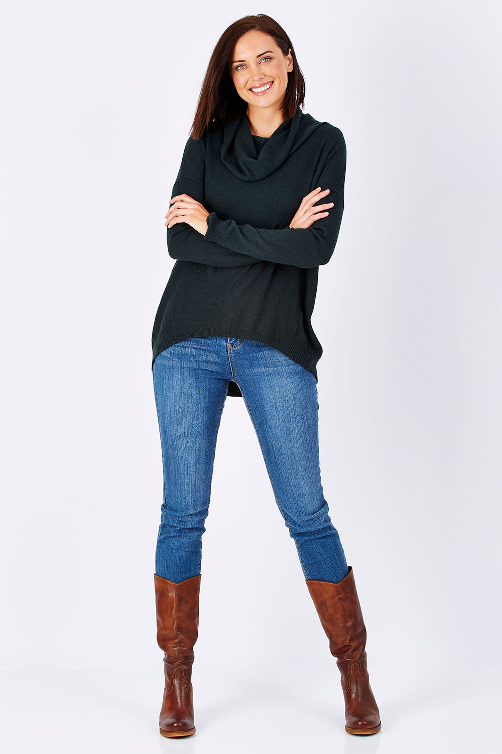 Model Perrie wearing size S of the Natural Rolled Neck Sweater in colour Alpine (Green), from the front, showing the whole outfit