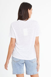 Model Madeline wearing size 10 of the Linen V Neck Top in colour White (White), from the back