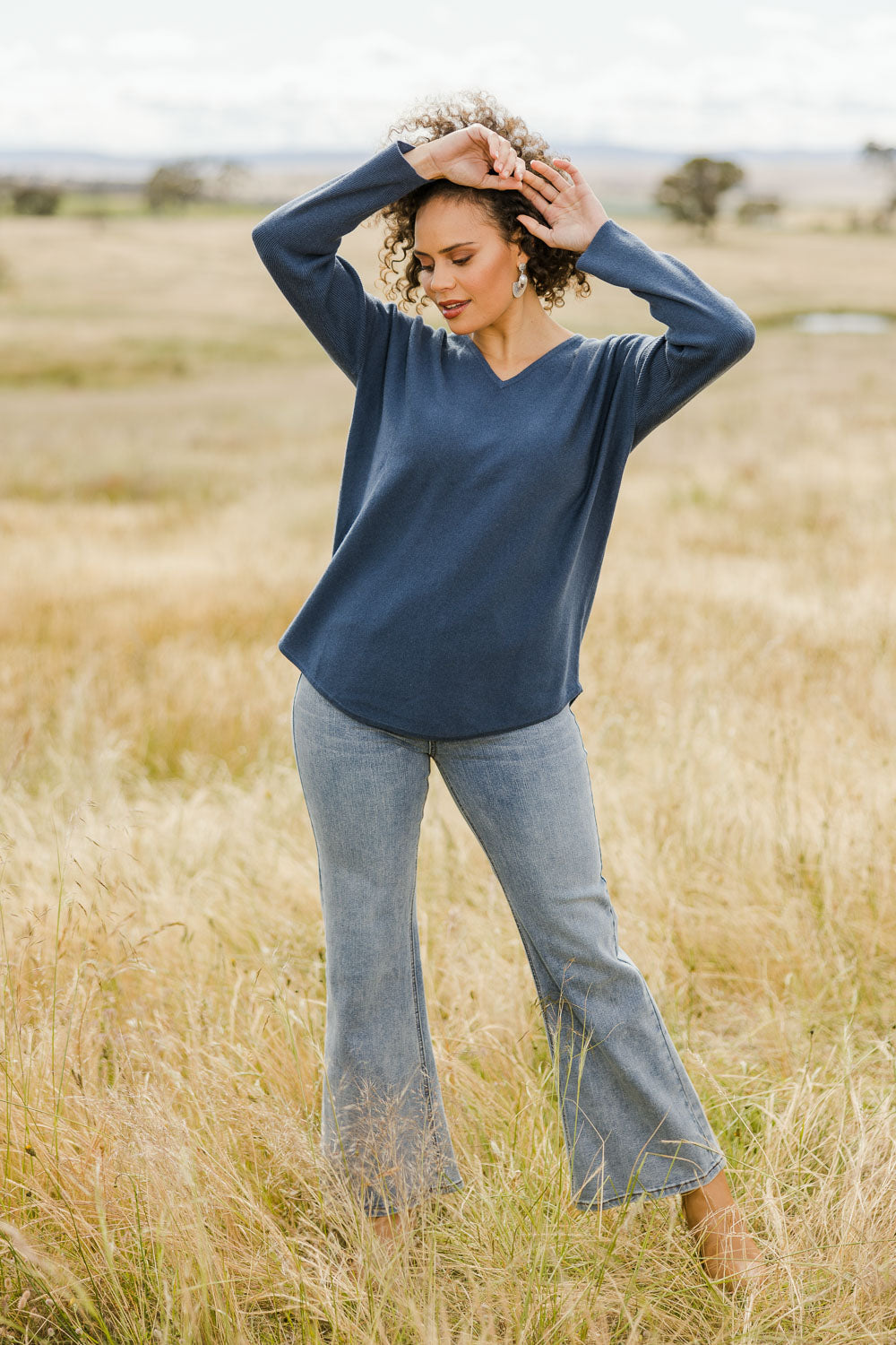 Model Lala wearing size S of the Wool Cashmere Sweater in colour Denim (Blue), from the front, showing the whole outfit