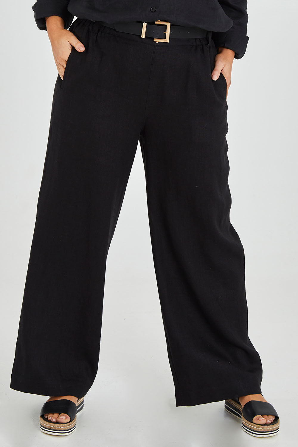Model Monique wearing size 14 of the Linen Wide Leg Pant in colour Black (Black), from the front, cropped image
