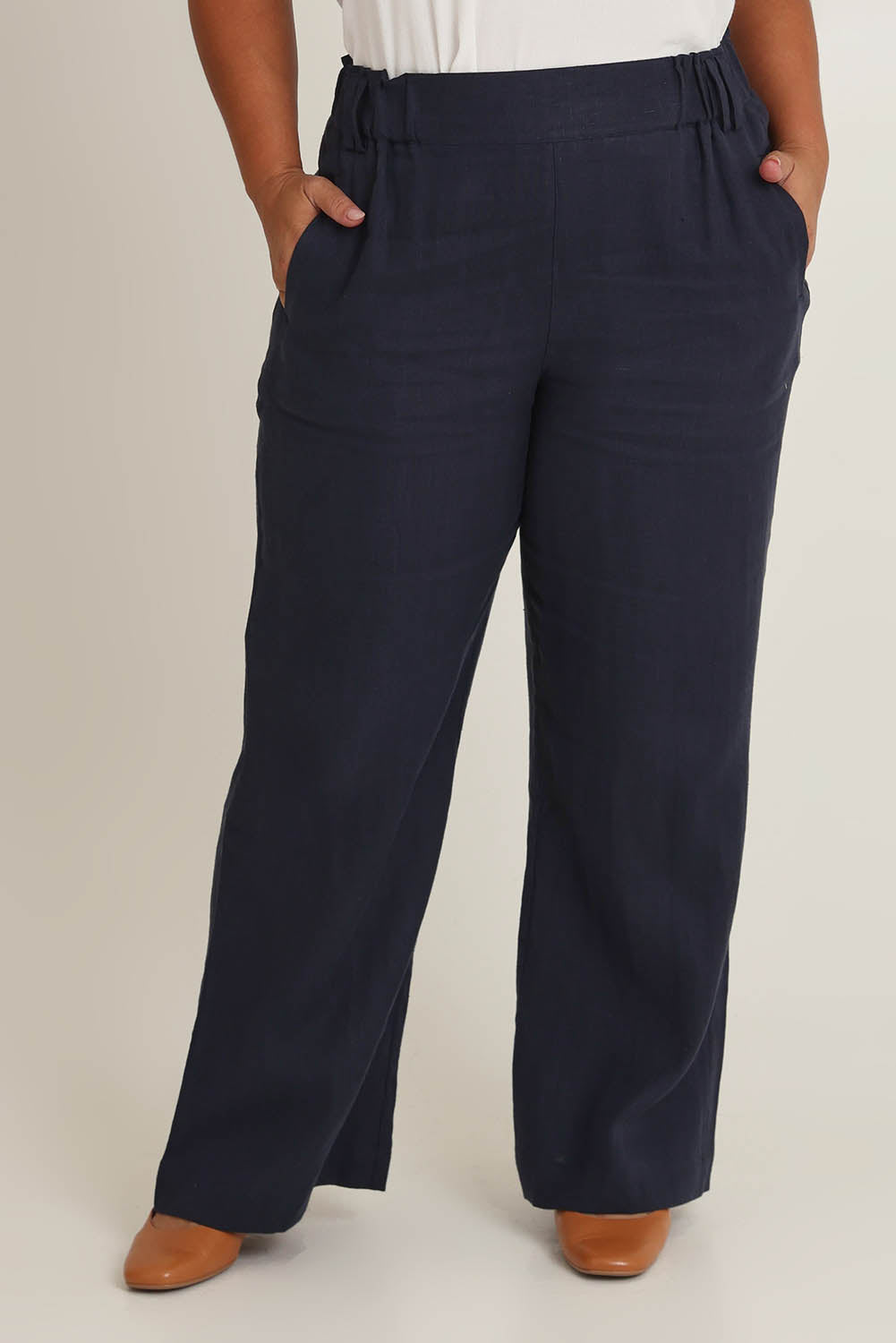 Model Ashleigh wearing size 16 of the Linen Wide Leg Pant in colour Navy (Blue), from the front, cropped image