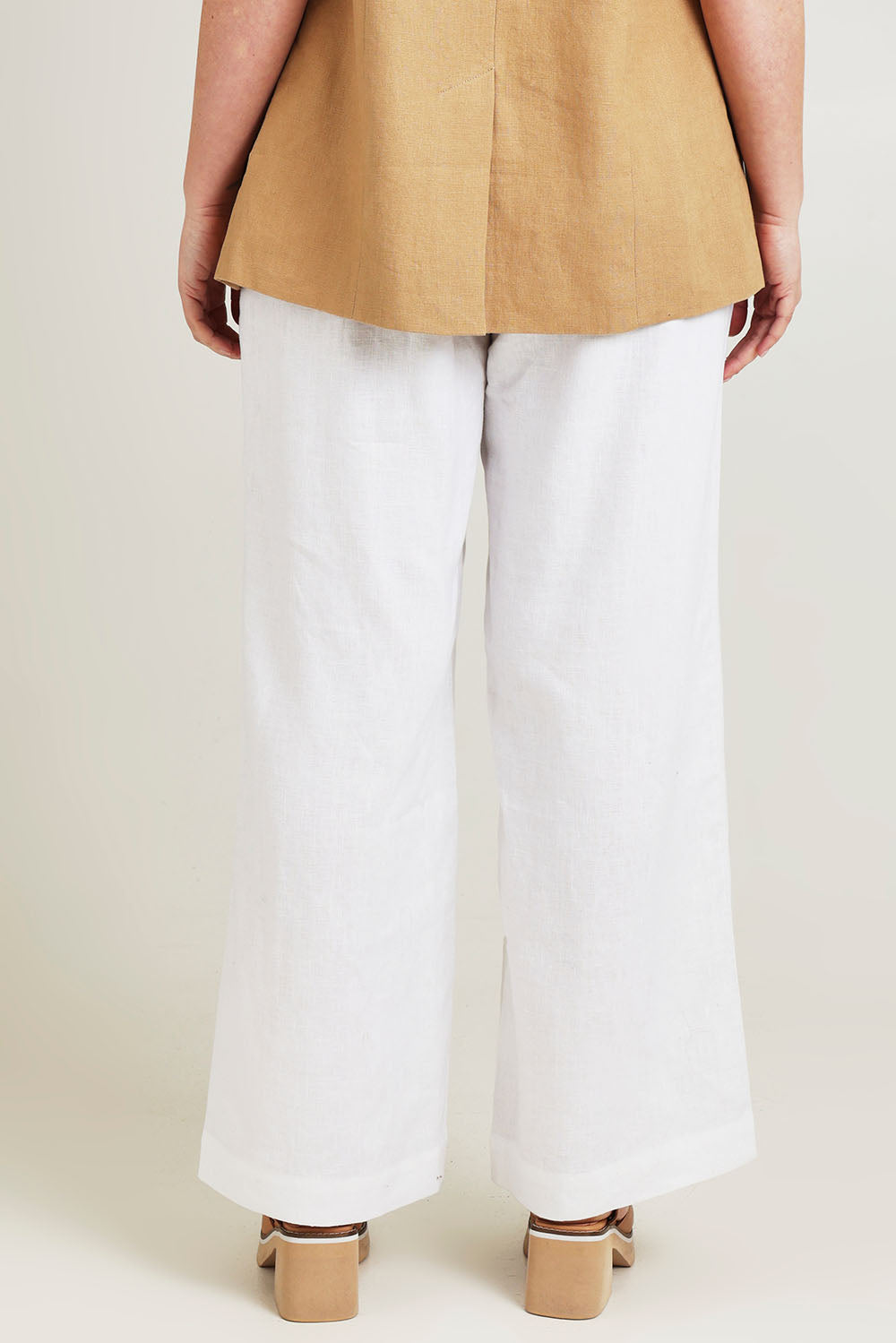 Model Jane wearing size 14 of the Linen Wide Leg Pant in colour White (White), from the back