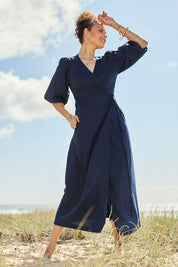Model Lala wearing size 10 of the Linen Cotton Puff Sleeve Wrap Dress in colour Navy (Blue), from the front, showing the whole outfit