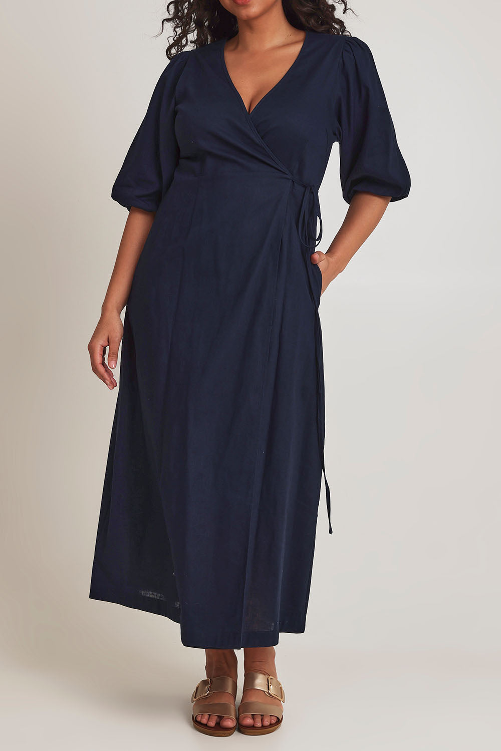 Model Terri-Leigh wearing size 14 of the Linen Cotton Puff Sleeve Wrap Dress in colour Navy (Blue), from the front, cropped image