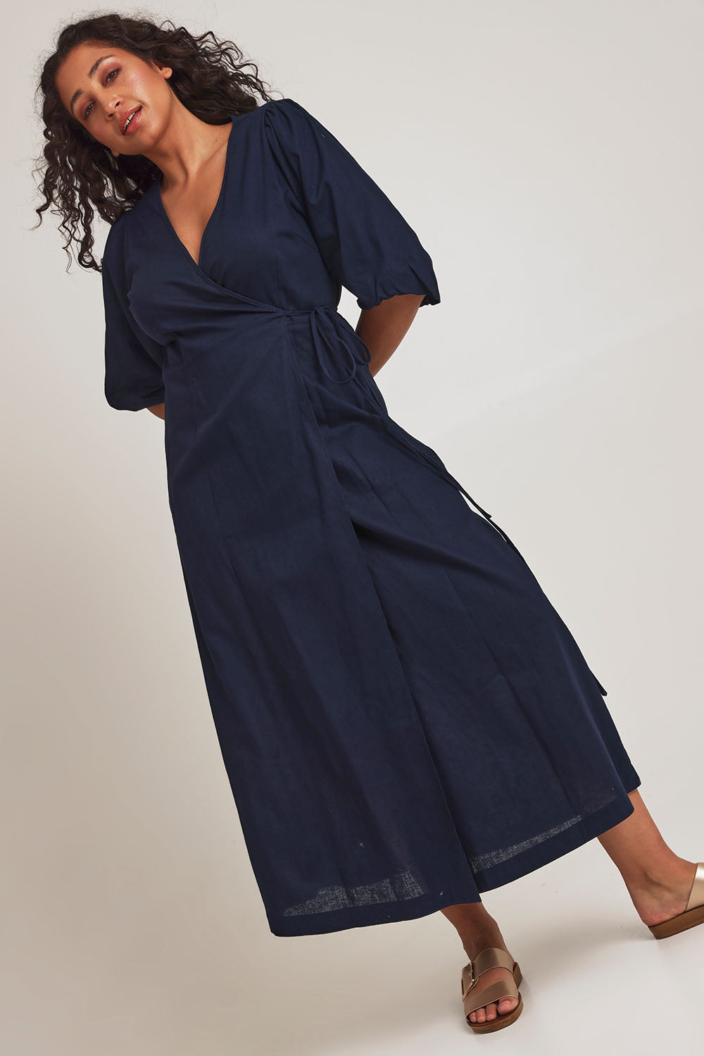 Model Terri-Leigh wearing size 14 of the Linen Cotton Puff Sleeve Wrap Dress in colour Navy (Blue), from the front, showing the whole outfit