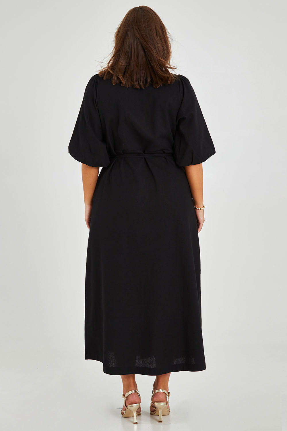Model Monique wearing size 14 of the Linen Cotton Blend Wrap Dress in colour Black (Black), from the back