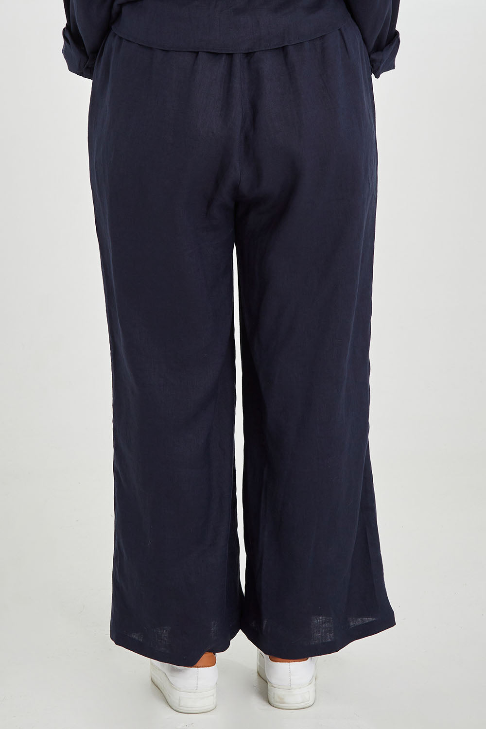 Model Monique wearing size 14 of the Linen Relaxed Pants in colour Navy (Blue), from the back