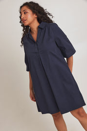 Model Terri-Leigh wearing size 14 of the Cotton Poplin Swing Dress in colour Dustyblue (Blue), from the front, cropped image