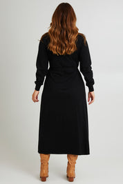 Model Laura wearing size L of the Cotton Cashmere Wrap Dress in colour Black (Black), from the back