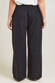 Model Jane wearing size 14 of the Ramie Tencel Straight Pant in colour Black (Black), from the back
