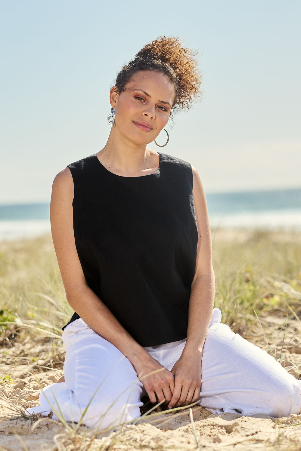 Model Lala wearing size 10 of the Linen Cotton Split Hem Tank in colour Black (Black), from the front, showing the whole outfit