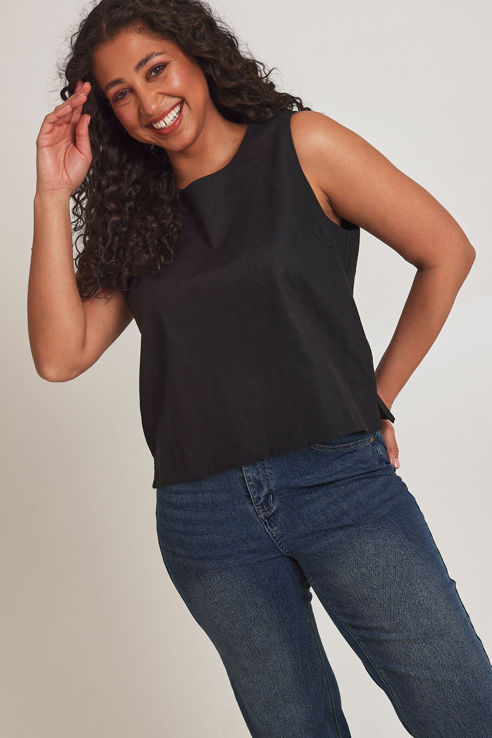 Model Terri-Leigh wearing size 14 of the Linen Cotton Split Hem Tank in colour Black (Black), from the front, cropped image