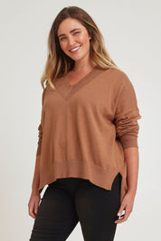 Model Chanel wearing size XL of the Cotton Cashmere V Neck Sweater in colour Caramel, from the front, cropped image