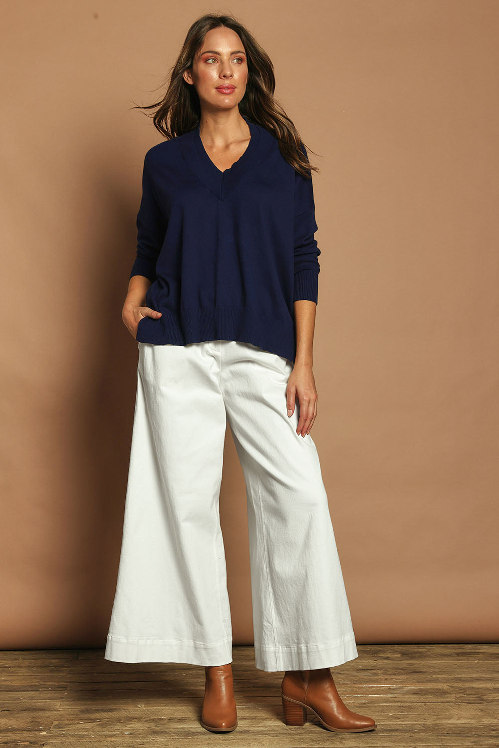 Model Madeline wearing size S of the Cotton Cashmere V Neck Sweater in colour Navy (Blue), from the front, showing the whole outfit