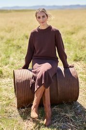 Model Tegan wearing size S of the Cotton Wool Cashmere Jumper Dress in colour Coco, from the front, showing the whole outfit