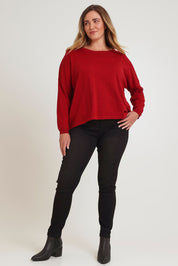 Model Chanel wearing size XL of the Cotton Cashmere Cross Back Sweater in colour Redrust (Red), from the front, showing the whole outfit