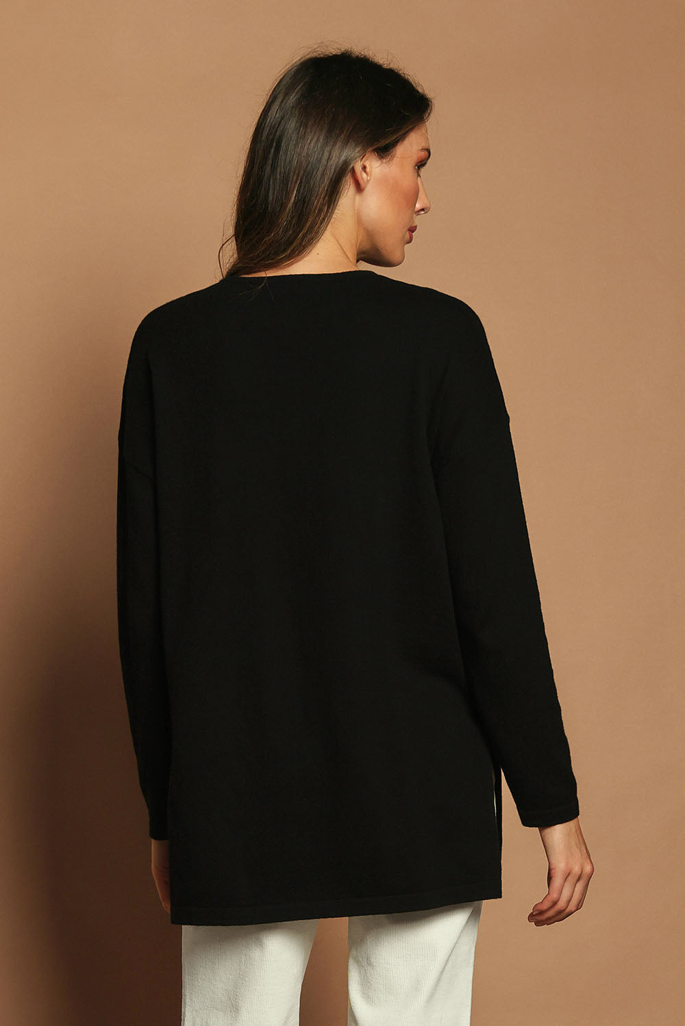 Model Madeline wearing size S of the Cotton Cashmere Tunic in colour Black (Black), from the back