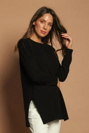Model Madeline wearing size S of the Cotton Cashmere Tunic in colour Black (Black), from the front, showing the whole outfit