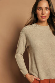 Model Madeline wearing size S of the Wool Cashmere Shoulder Cable Knit Sweater in colour Fawn, from the front, cropped image