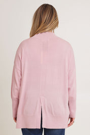 Model Chanel wearing size XL of the Merino Wool Back Split Tunic in colour Softpink (Pink), from the back
