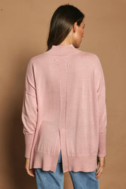 Model Madeline wearing size S of the Merino Wool Back Split Tunic in colour Softpink (Pink), from the back