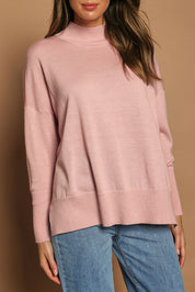 Model Madeline wearing size S of the Merino Wool Back Split Tunic in colour Softpink (Pink), from the front, cropped image