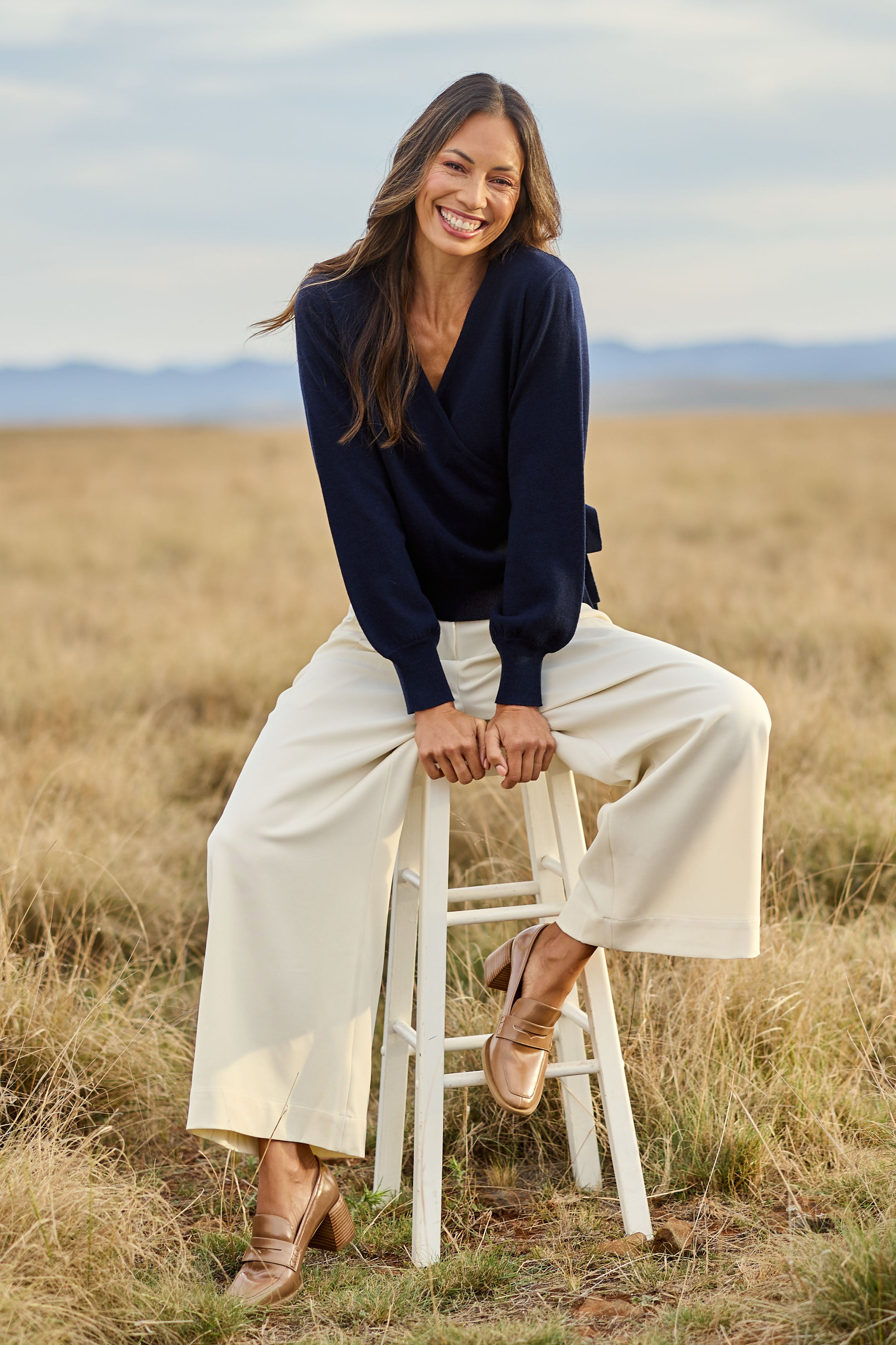 Model Amanda wearing size S of the Wool Cashmere Wrap Sweater in colour Peacoat (Blue), from the front, showing the whole outfit