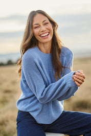 Model Amanda wearing size S of the Wool Cashmere Sweater in colour Softblue (Blue), from the front, showing the whole outfit