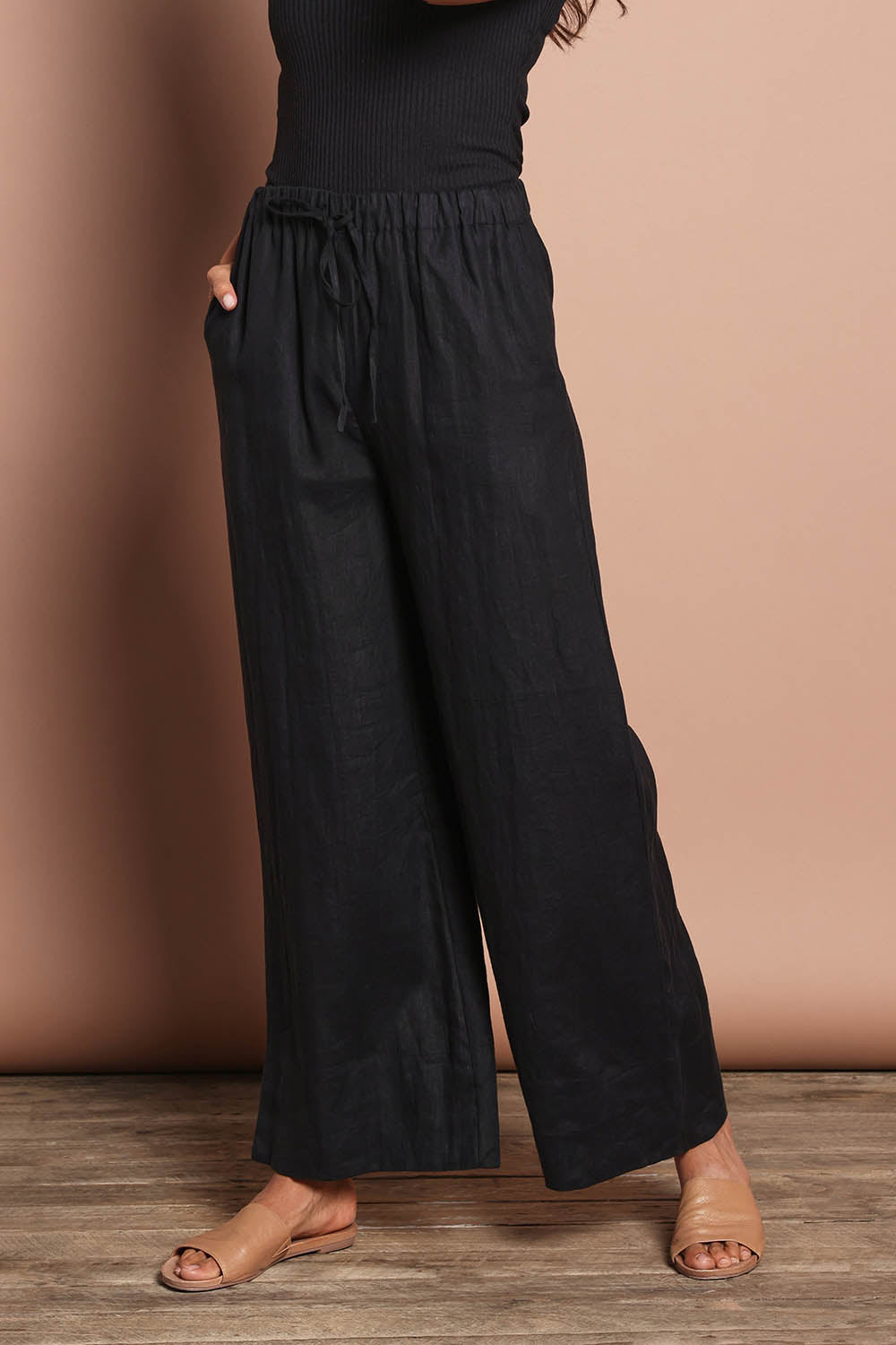 Model Amanda wearing size 10 of the Linen Drawstring Pant in colour Black (Black), from the front, cropped image