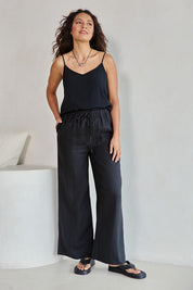 Model Tahneei wearing size 10 of the Linen Drawstring Pant - Black in colour Black, from the front