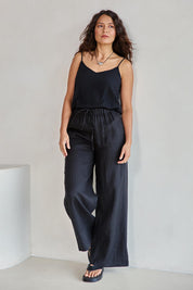 Model Tahneei wearing size 10 of the Linen Drawstring Pant - Black in colour Black, from the front