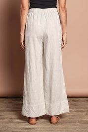Model Amanda wearing size 10 of the Linen Drawstring Pant in colour Natural, from the back
