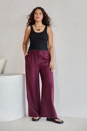 Model Tahneei wearing size 10 of the Linen Drawstring Pant – Plum in colour Plum, from the front