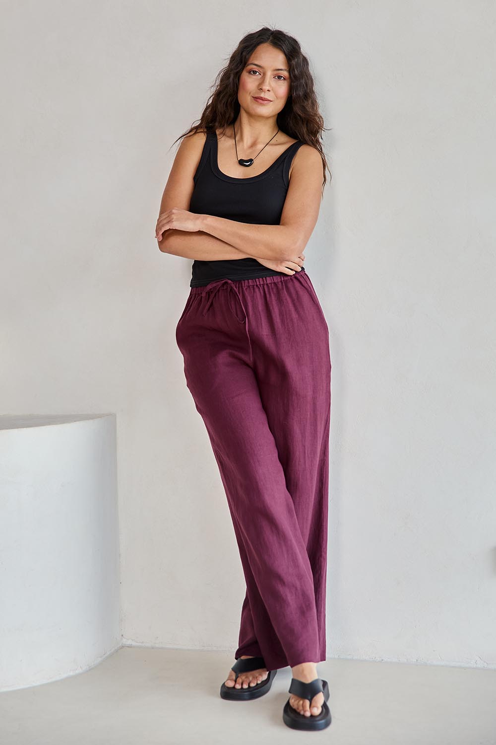 Model Tahneei wearing size 10 of the Linen Drawstring Pant – Plum in colour Plum, from the front