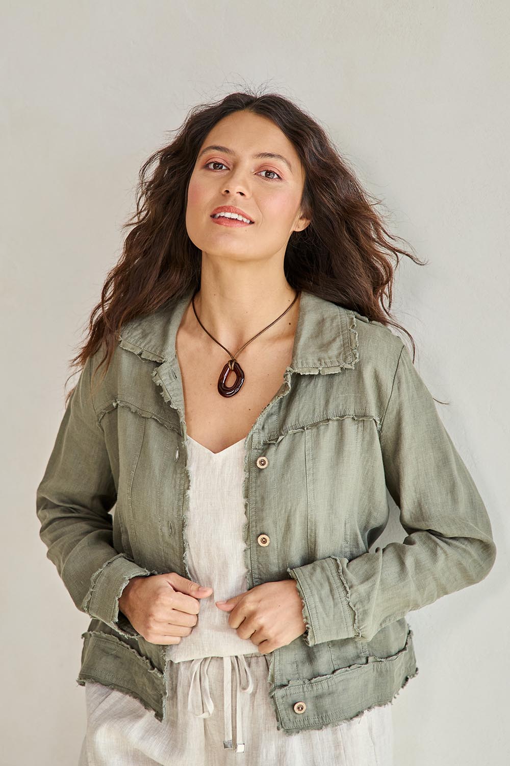 Model Tahneei wearing size 10 of the Linen Relaxed Jacket – Olive in colour Olive, in a cropped view