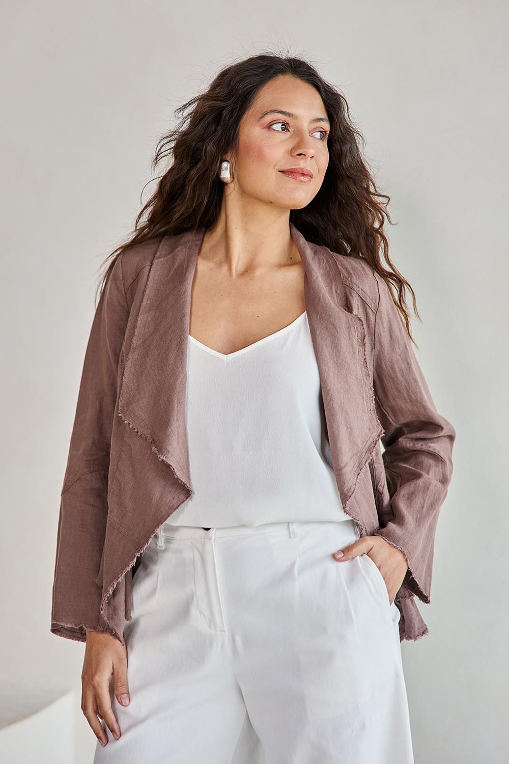 Model Tahneei wearing size 10 of the Linen Draped Jacket – Coffee in colour Coffee, from an angle