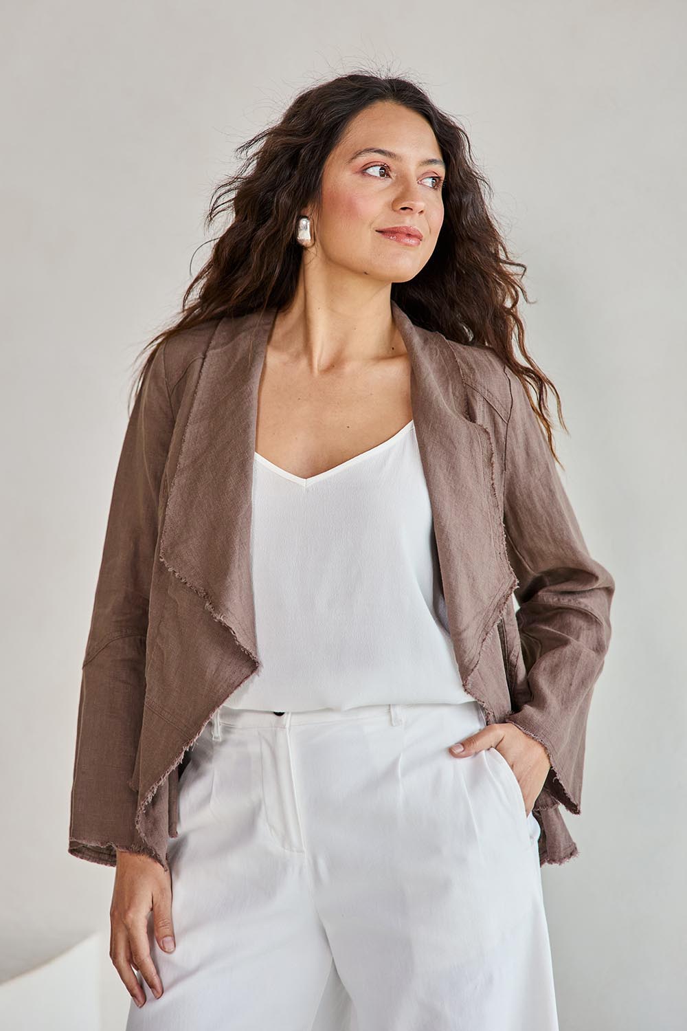 Model Tahneei wearing size 10 of the Linen Draped Jacket – Coffee in colour Coffee, from an angle