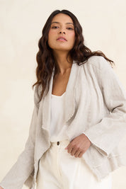Model Tahneei wearing size 10 of the Linen Draped Jacket – Natural in colour Natural, from an angle