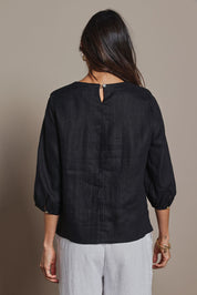 Model Amanda wearing size 10 of the Linen 3/4 Sleeve Top in colour Black (Black), from the back