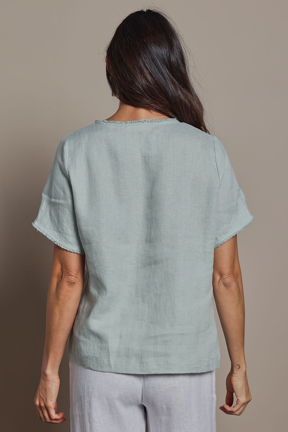 Model Amanda wearing size 10 of the Linen Short Sleeve Top in colour Seafoam (Green), from the back