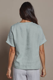Model Amanda wearing size 10 of the Linen Short Sleeve Top in colour Seafoam (Green), from the back
