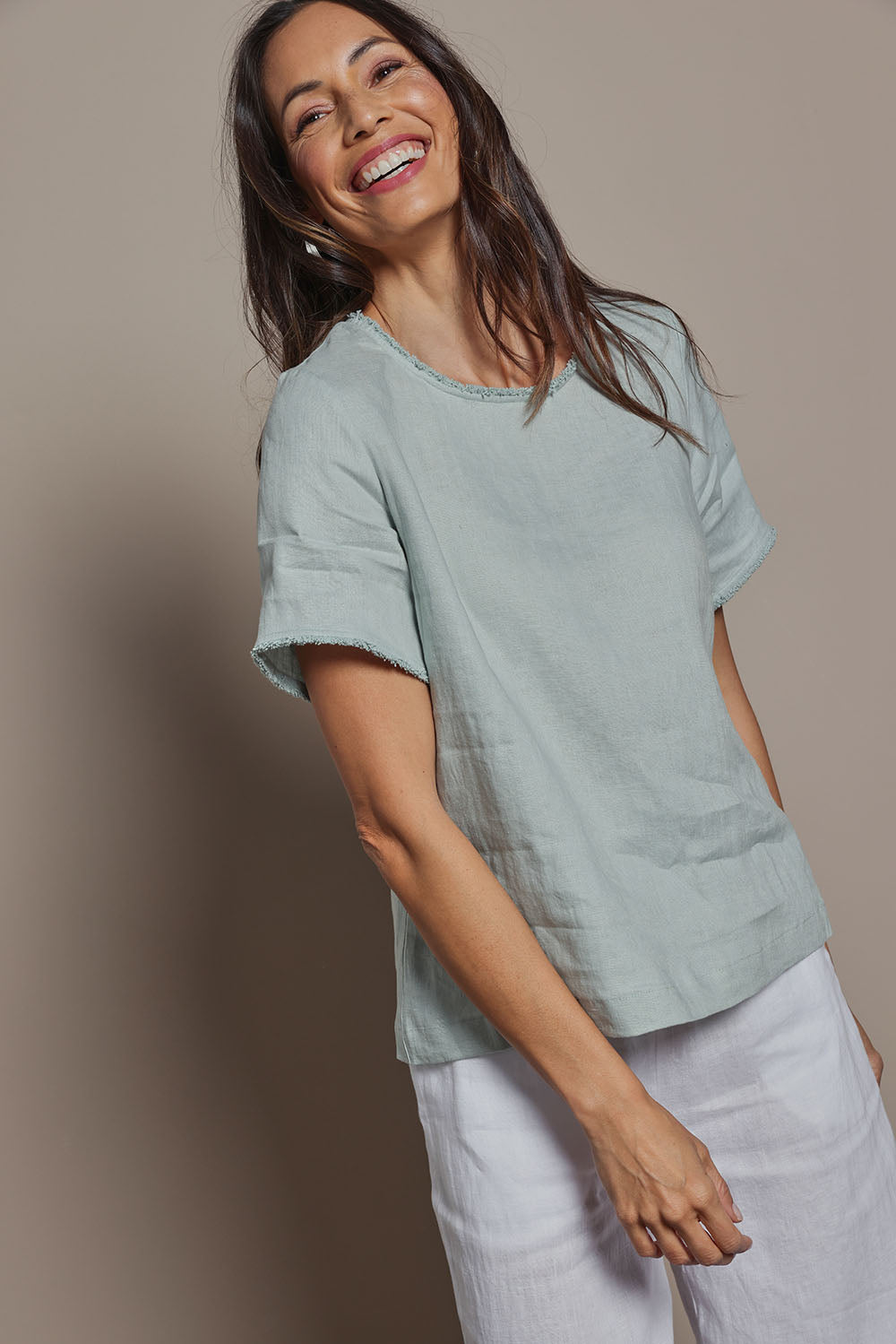 Model Amanda wearing size 10 of the Linen Short Sleeve Top in colour Seafoam (Green), from the front, cropped image
