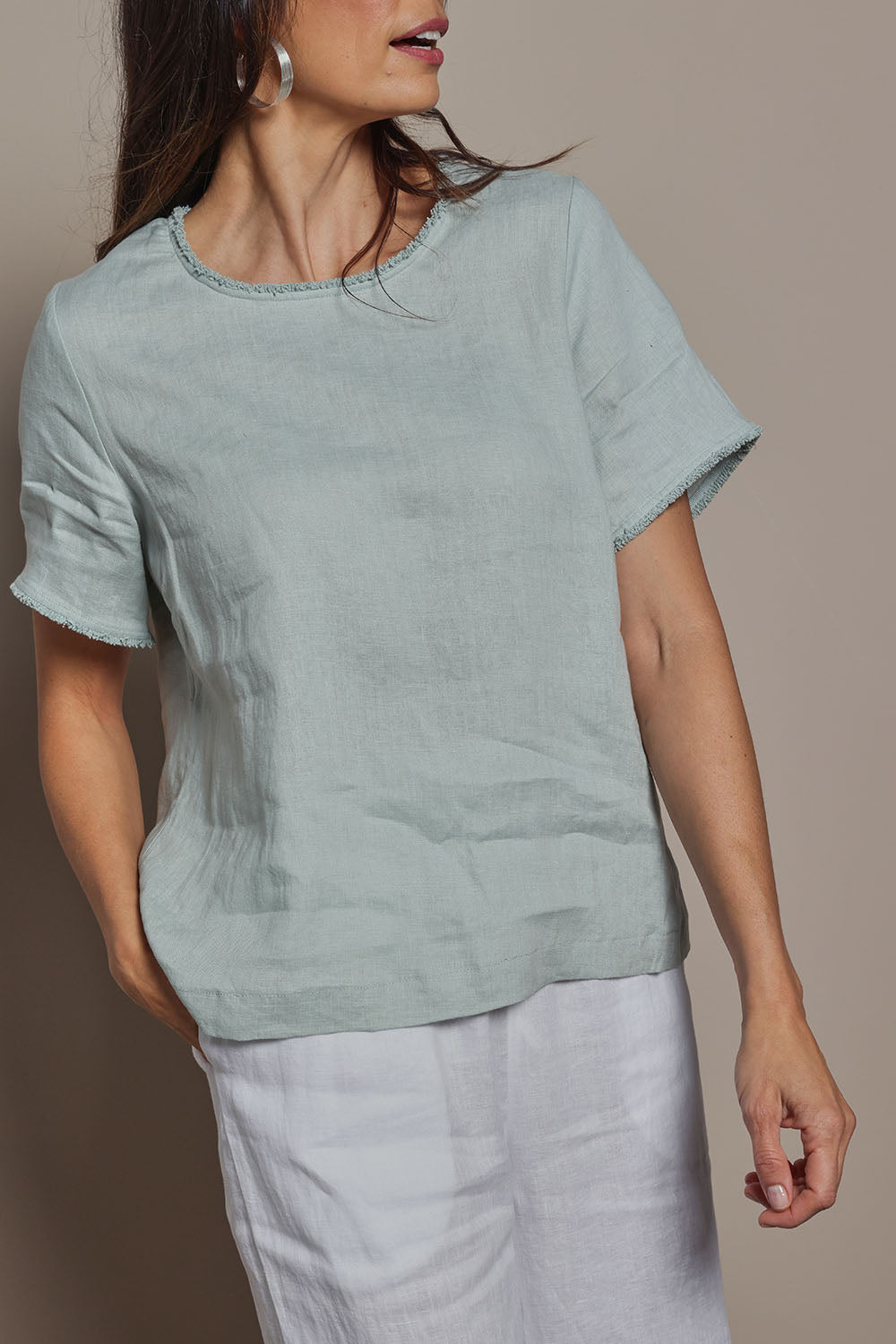 Model Amanda wearing size 10 of the Linen Short Sleeve Top in colour Seafoam (Green), from the front, cropped image
