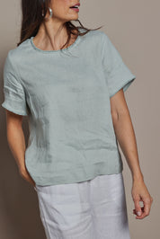 Model Amanda wearing size 10 of the Linen Short Sleeve Top in colour Seafoam (Green), from the front, cropped image