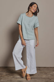 Model Amanda wearing size 10 of the Linen Short Sleeve Top in colour Seafoam (Green), from the front, showing the whole outfit