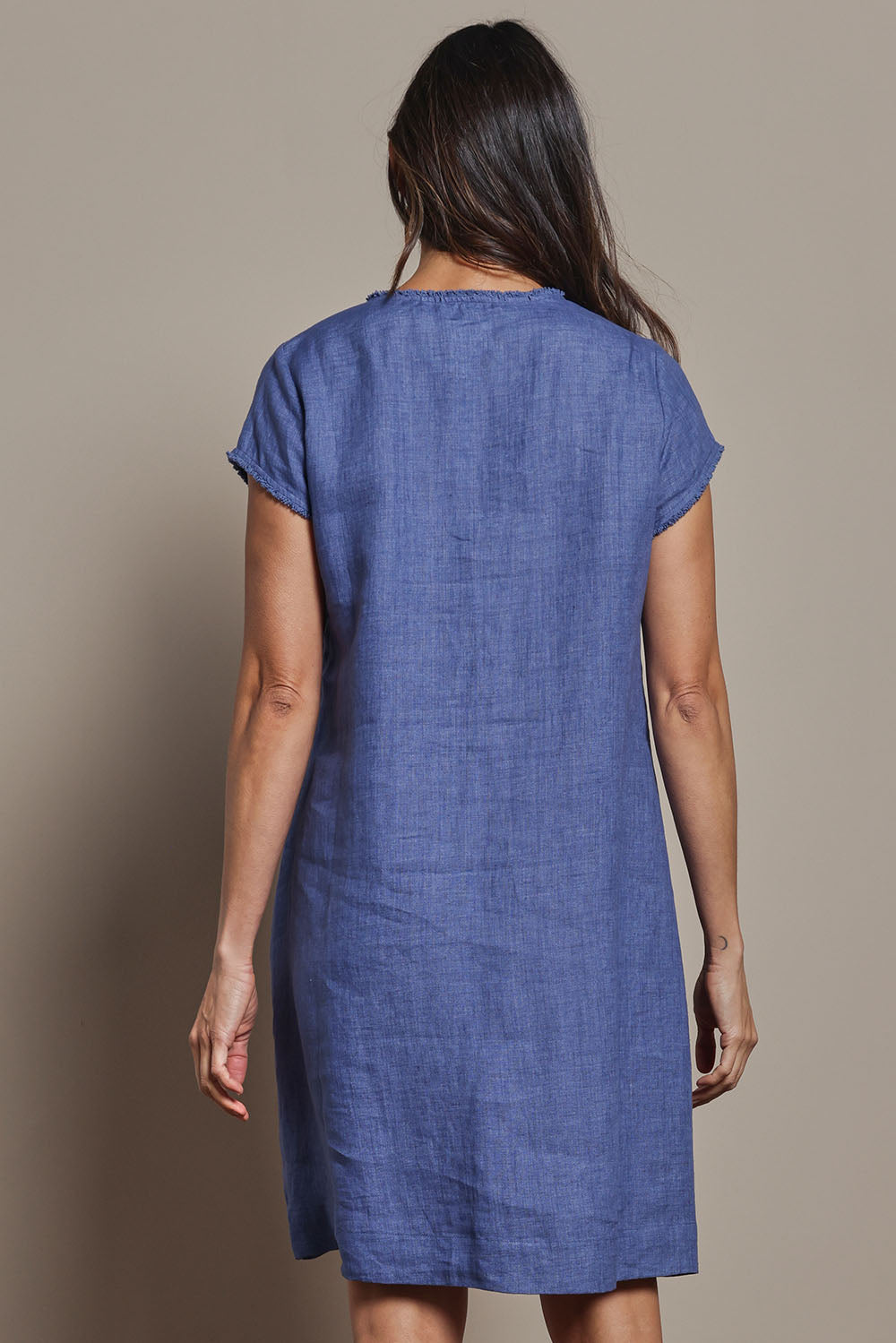 Model Amanda wearing size 10 of the Linen V Neck Shift Dress in colour Denim (Blue), from the back