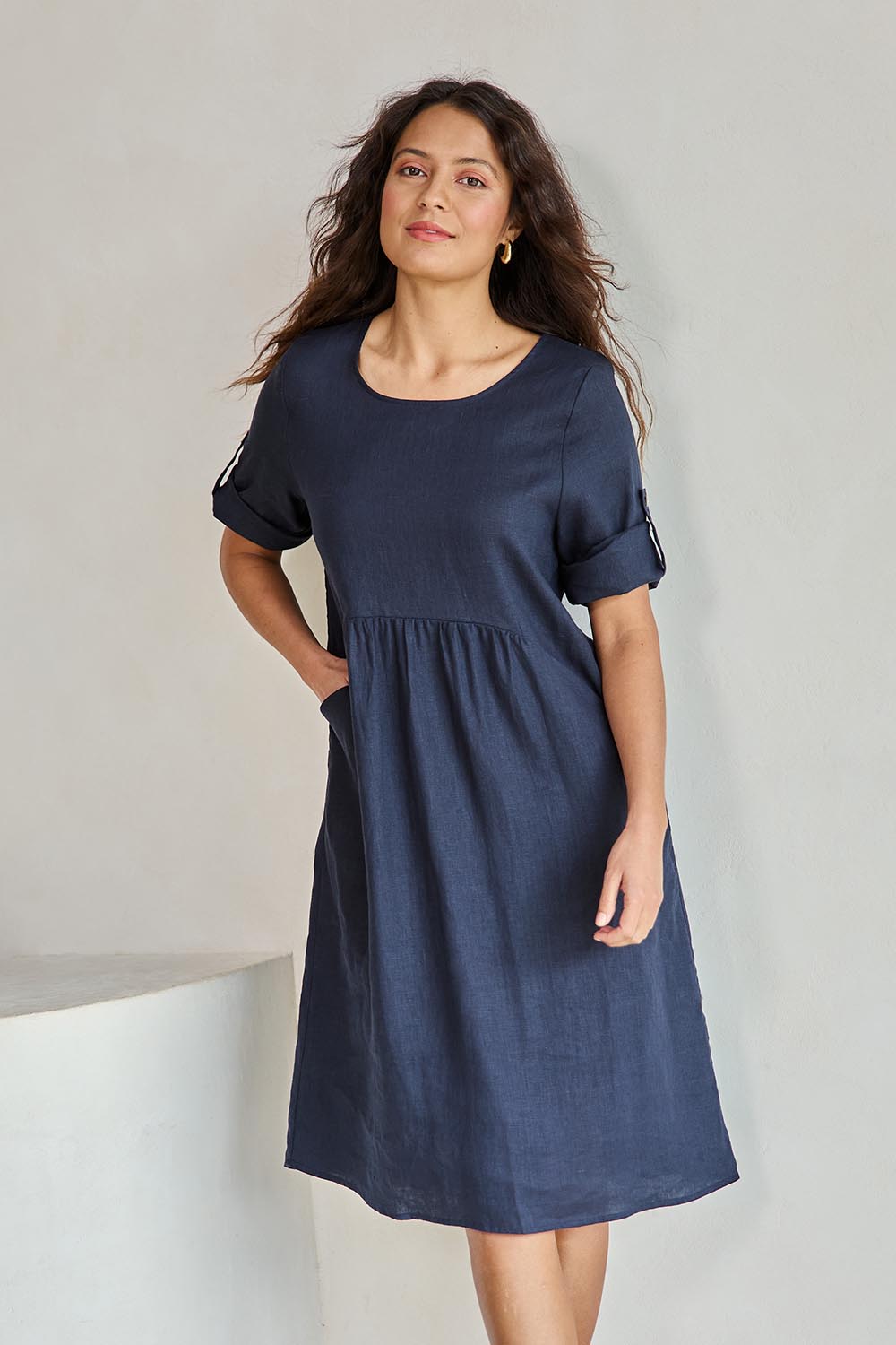 Model Tahneei wearing size 10 of the Linen Pocket Dress – Navy in colour Navy, in a cropped view