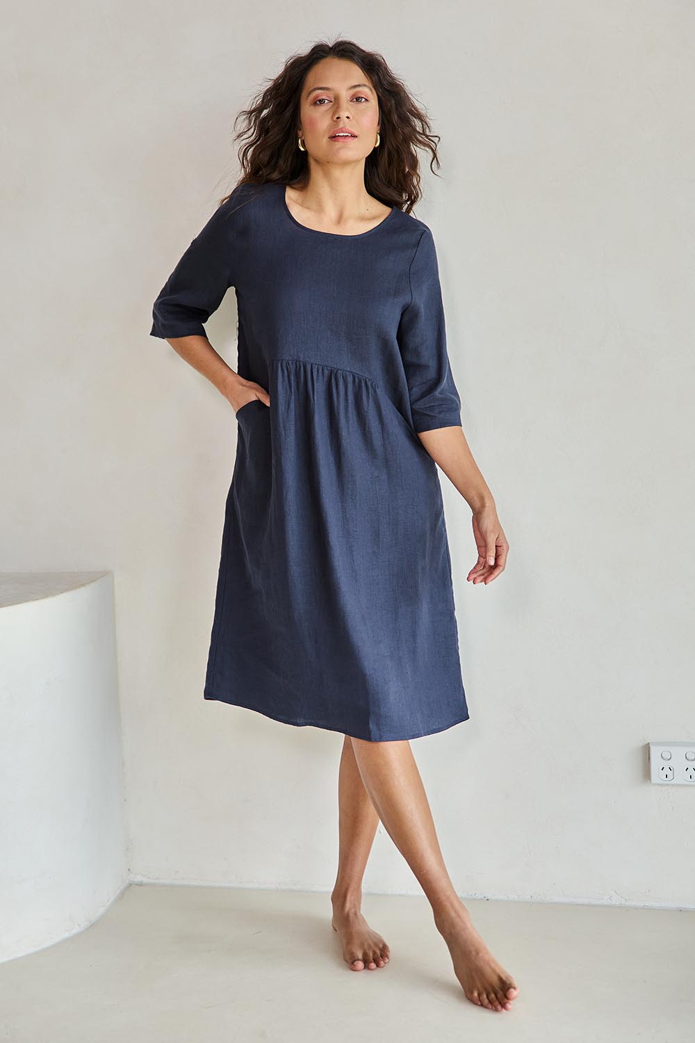 Model Tahneei wearing size 10 of the Linen Pocket Dress – Navy in colour Navy, from the front